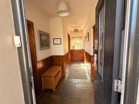 A hallway with a bench and picture frame at The Farmhouse in Boggle Hole near Robin Hood's Bay
