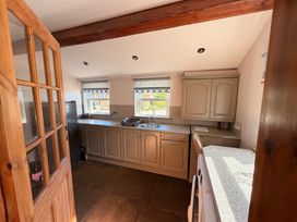 A kitchen with cabinets and a sink at The Farmhouse in Boggle Hole near Robin Hood's Bay