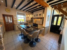 A kitchen with a table and chairs at The Farmhouse in Boggle Hole near Robin Hood's Bay