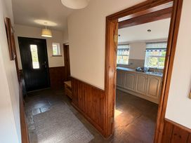 A hallway with a door leading to the kitchen at The Farmhouse in Boggle Hole near Robin Hood's Bay
