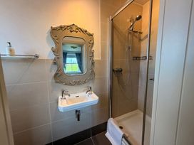 A bathroom with a sink and shower at The Farmhouse in Boggle Hole near Robin Hood's Bay