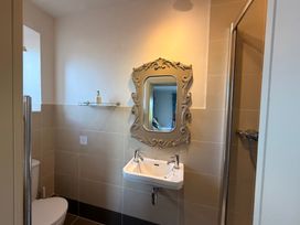 A bathroom with a sink and shower at The Farmhouse in Boggle Hole near Robin Hood's Bay