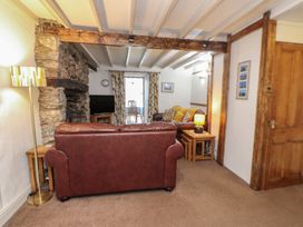 A living room with a sofa and television at Dolfor in Nefyn