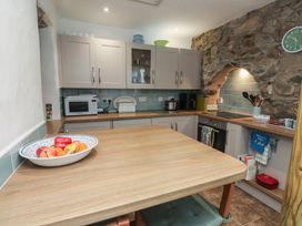 A kitchen with cabinets and appliances at Dolfor in Nefyn