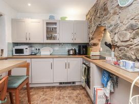 A kitchen with cabinets and appliances at Dolfor in Nefyn