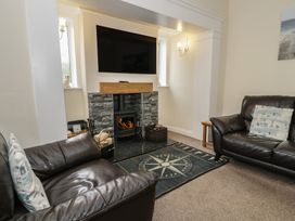 A living room with a fireplace and television at Roma in Rhos-on-Sea