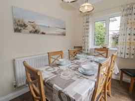 A dining room with a table and chairs at Roma in Rhos-on-Sea