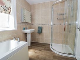 A bathroom with a bathtub and shower at Roma in Rhos-on-Sea