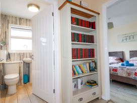 A bathroom with a toilet and sink at Merlin's Retreat in Tintagel