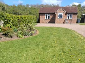 A house with a garden and pathway at Lawn Lodge in Ashleworth