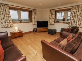 A living room with sofas and a television at Long Cart Cottage Embleton
