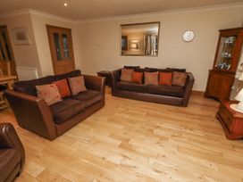 A living room with sofas and a coffee table at Long Cart Cottage in Embleton