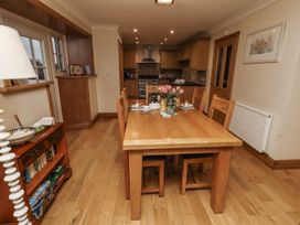 A dining room with a table and chairs at Long Cart Cottage in Embleton