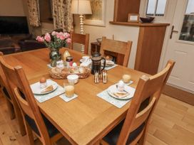 A dining room with a table set for breakfast at Long Cart Cottage in Embleton
