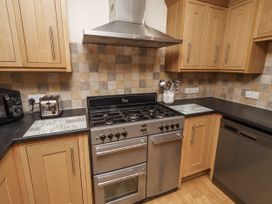 A kitchen with an oven and appliances at Long Cart Cottage in Embleton