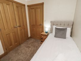 A bedroom with a single bed and a bedside table at Long Cart Cottage Embleton