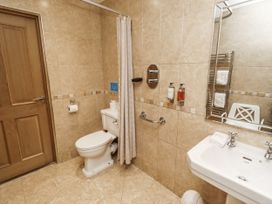 A bathroom with a toilet and sink at Long Cart Cottage in Embleton