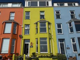 A colorful building with green, orange, and blue walls at The View in Criccieth