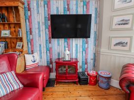 A living room with a television mounted on the wall at The View in Criccieth