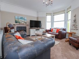 A living room with a sofa and television at The View in Criccieth