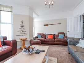 A living room with a brown sofa and a coffee table at The View in Criccieth