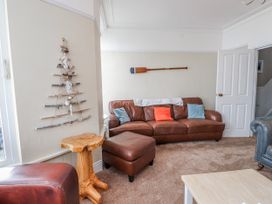 A living room with a sofa and decorative wall art at The View in Criccieth