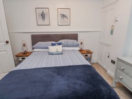 A bedroom with a bed and bedside table at The View in Criccieth