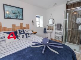 A bedroom with a bed, mirror, and shower at The View in Criccieth