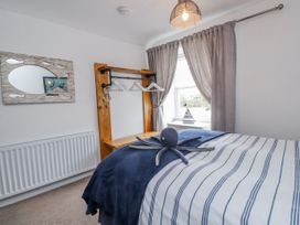 A bedroom with a bed and decorative octopus at The View in Criccieth