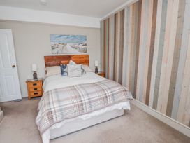 A bedroom with a bed and bedside tables at The View in Criccieth