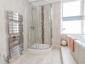 A bathroom with a shower and bathtub at The View in Criccieth