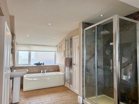 A bathroom with a bathtub and shower at The View in Criccieth