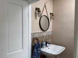 A bathroom with a sink, mirror, and towel at The View in Criccieth