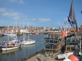 A harbor with boats and fishing traps at Kingfisher in Whitby