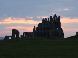 Ruins of a building against a colorful sky at Kingfisher in Whitby