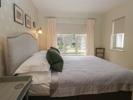 A bedroom with a bed and window at Gable End in Coniston near Hawkshead