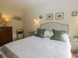 A bedroom with a bed and bedside table at Gable End in Coniston near Hawkshead