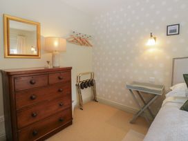 A bedroom with a chest of drawers and a lamp at Gable End in Coniston near Hawkshead
