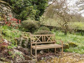 A wooden bench in a garden at Gable End in Coniston near Hawkshead