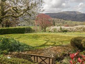 A garden with grass and trees at Gable End in Coniston near Hawkshead