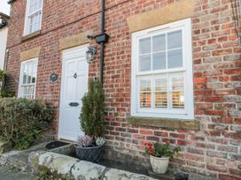 An outdoor view of a brick exterior with a door and windows at Croft View in Fylingthorpe near Robin Hood's Bay