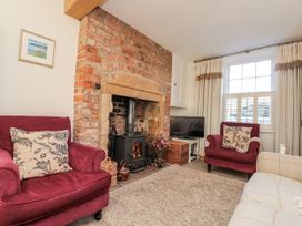 A living room with a fireplace and a sofa at Croft View Fylingthorpe near Robin Hood's Bay
