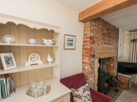 A living room with a shelf and fireplace at Croft View in Fylingthorpe near Robin Hood's Bay
