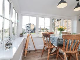 A dining room with a table and chairs at Croft View in Fylingthorpe near Robin Hood's Bay