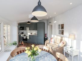 A dining room with a table and flowers at Croft View near Fylingthorpe Robin Hood's Bay