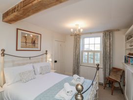 A bedroom with a bed and shelves at Croft View Fylingthorpe near Robin Hood's Bay