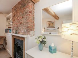 A living room with a brick wall and fireplace at Croft View in Fylingthorpe near Robin Hood's Bay