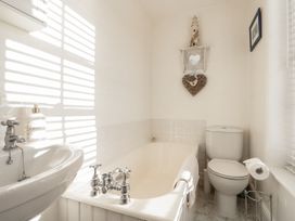 A bathroom with a bathtub, toilet, and sink at Croft View in Fylingthorpe near Robin Hood's Bay