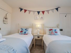 A bedroom with two single beds and a bedside table at Croft View in Fylingthorpe near Robin Hood's Bay