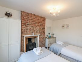 A bedroom with twin beds and a fireplace at Croft View Fylingthorpe near Robin Hood's Bay